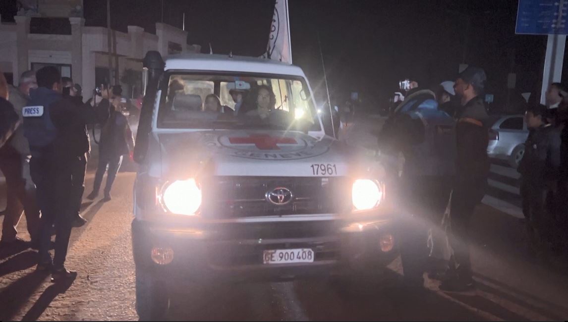 A Red Cross convoy carrying released hostages arrives at the Rafah border crossing on Wednesday